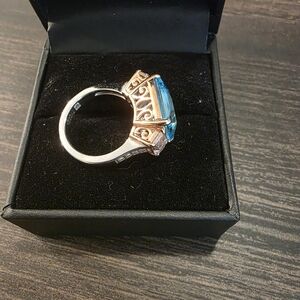 Three-stone "Trilogy" ring with an accented band.